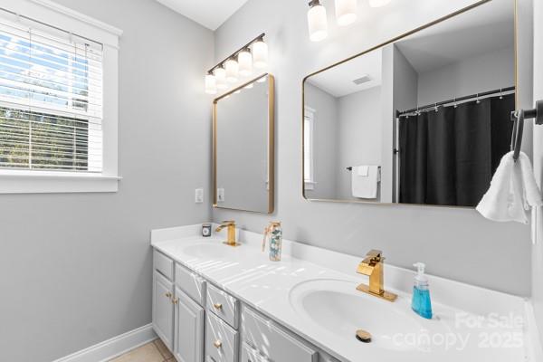 1761 Lakeland Trail Drive Tega Cay, SC 29708 - Photo 25 of 46 a bathroom with a sink and a mirror