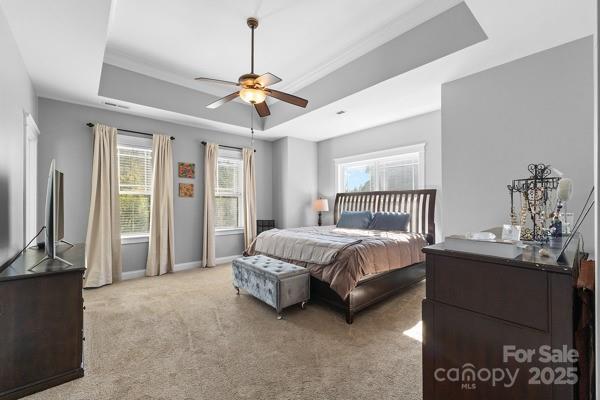 1761 Lakeland Trail Drive Tega Cay, SC 29708 - Photo 32 of 46 a spacious bedroom with a bed and a chandelier