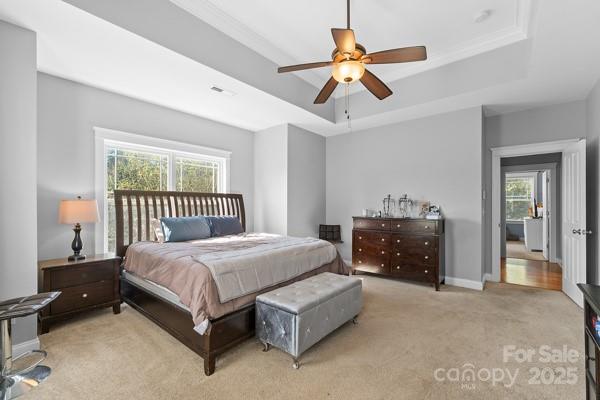 1761 Lakeland Trail Drive Tega Cay, SC 29708 - Photo 33 of 46 a bedroom with a bed and a chandelier