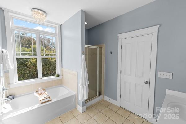 1761 Lakeland Trail Drive Tega Cay, SC 29708 - Photo 35 of 46 a bathroom with a tub shower and a sink
