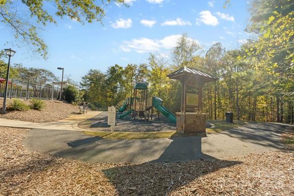 1761 Lakeland Trail Drive Tega Cay, SC 29708 - Photo 42 of 46 a view of a yard with trees in the background