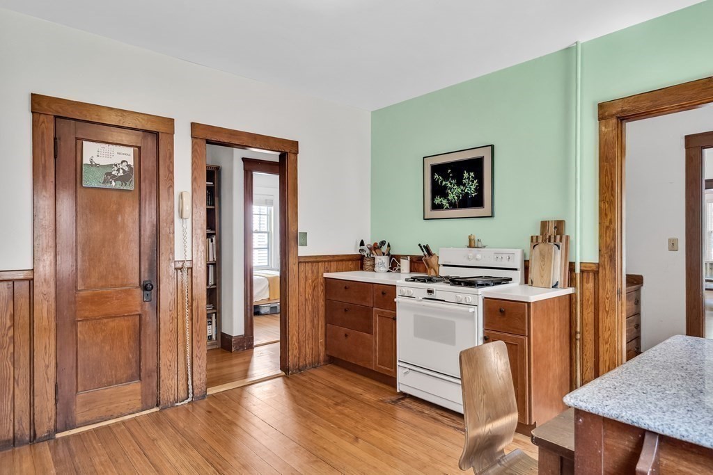 125 Sumner Road, Unit 1 Brookline, MA 02445 - Photo 13 of 22 a kitchen with a stove a refrigerator and a table