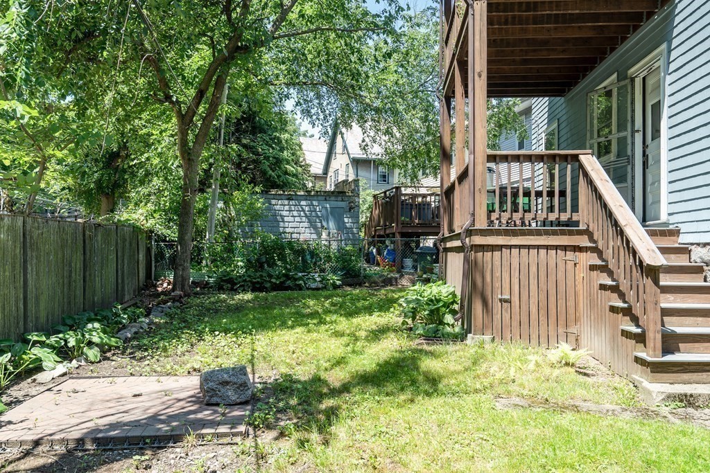 125 Sumner Road, Unit 1 Brookline, MA 02445 - Photo 21 of 22 a view of backyard with potted plants and large tree