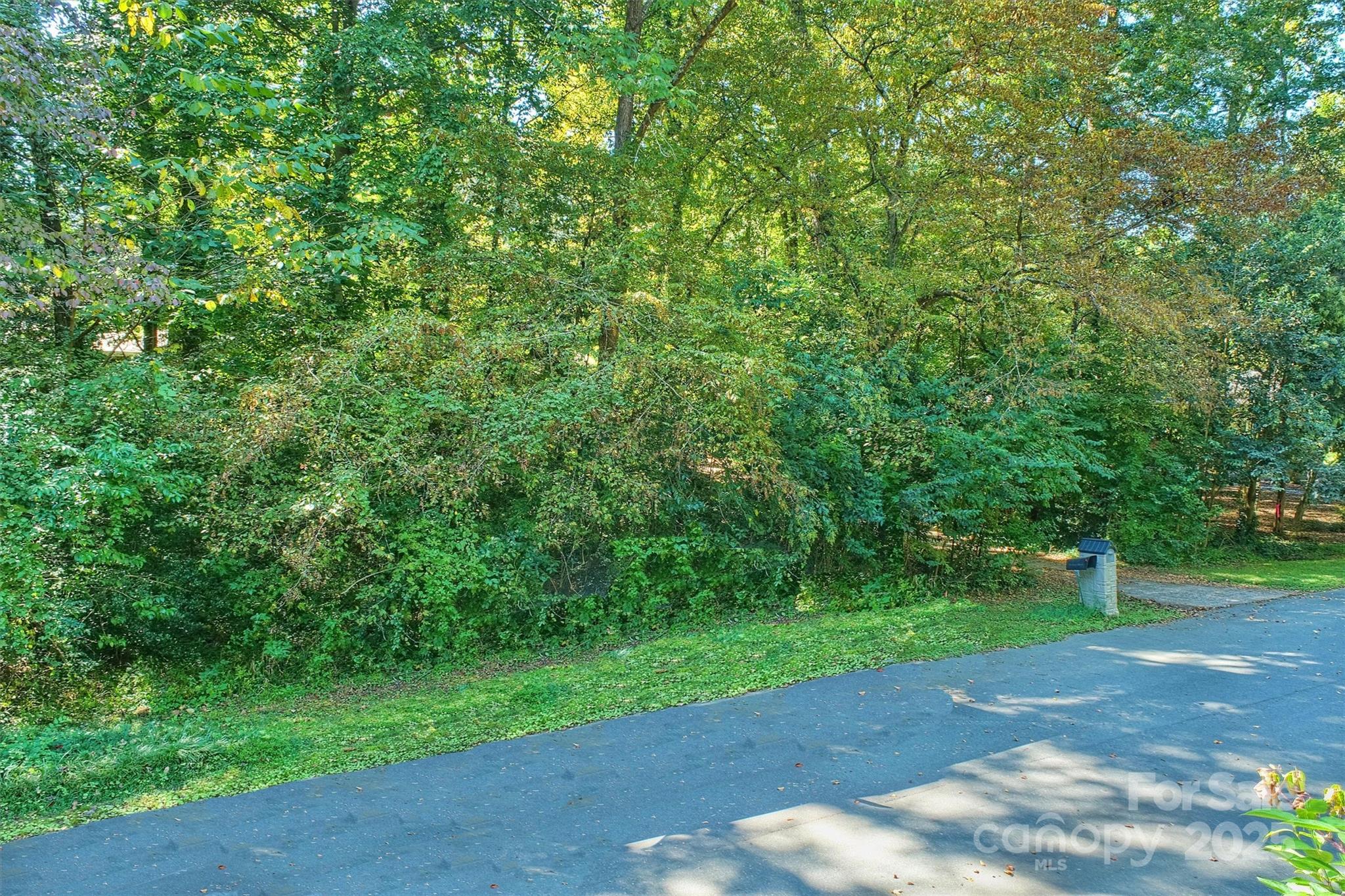 5700 Glenkirk Road, Unit 25 Charlotte, NC 28209 - Photo 10 of 12 a view of a street with a trees