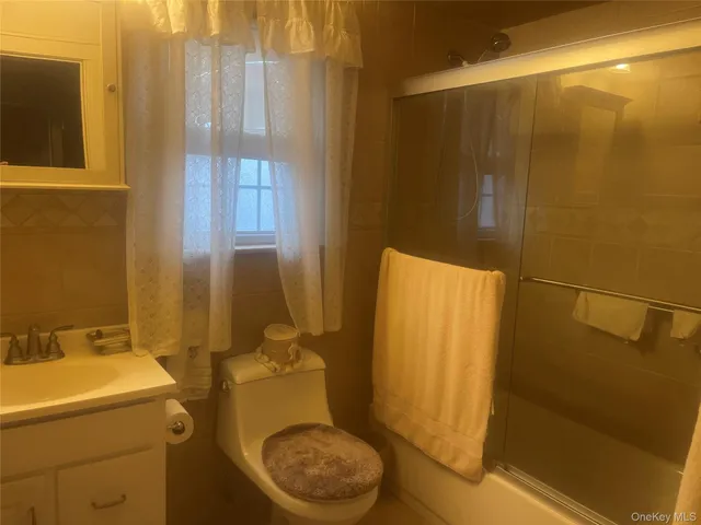 a bedroom with a bed and large windows