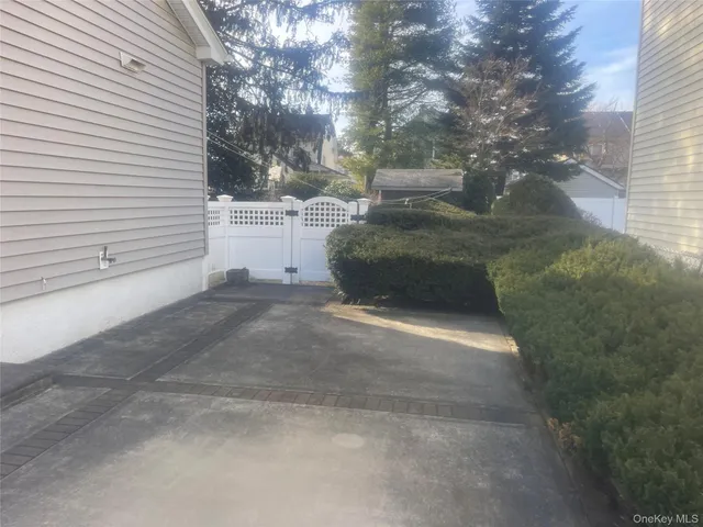 a view of a patio with chair and tables back yard of the house