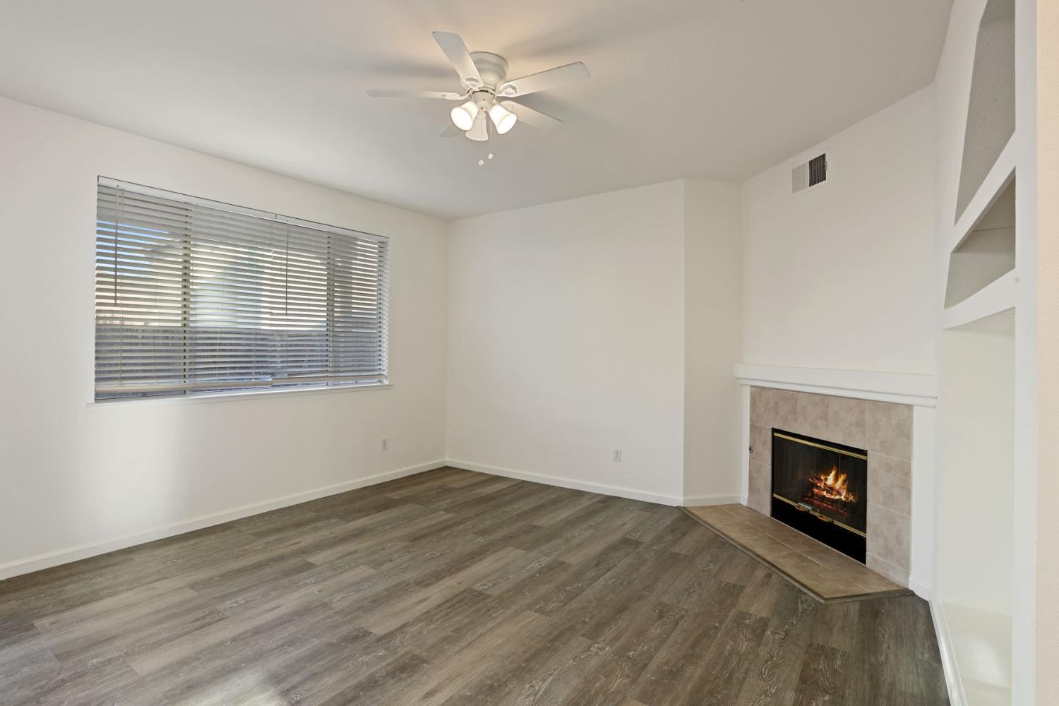 4882 Timepiece Circle Stockton, CA 95219 - Photo 13 of 43 a view of empty room with fireplace and fan