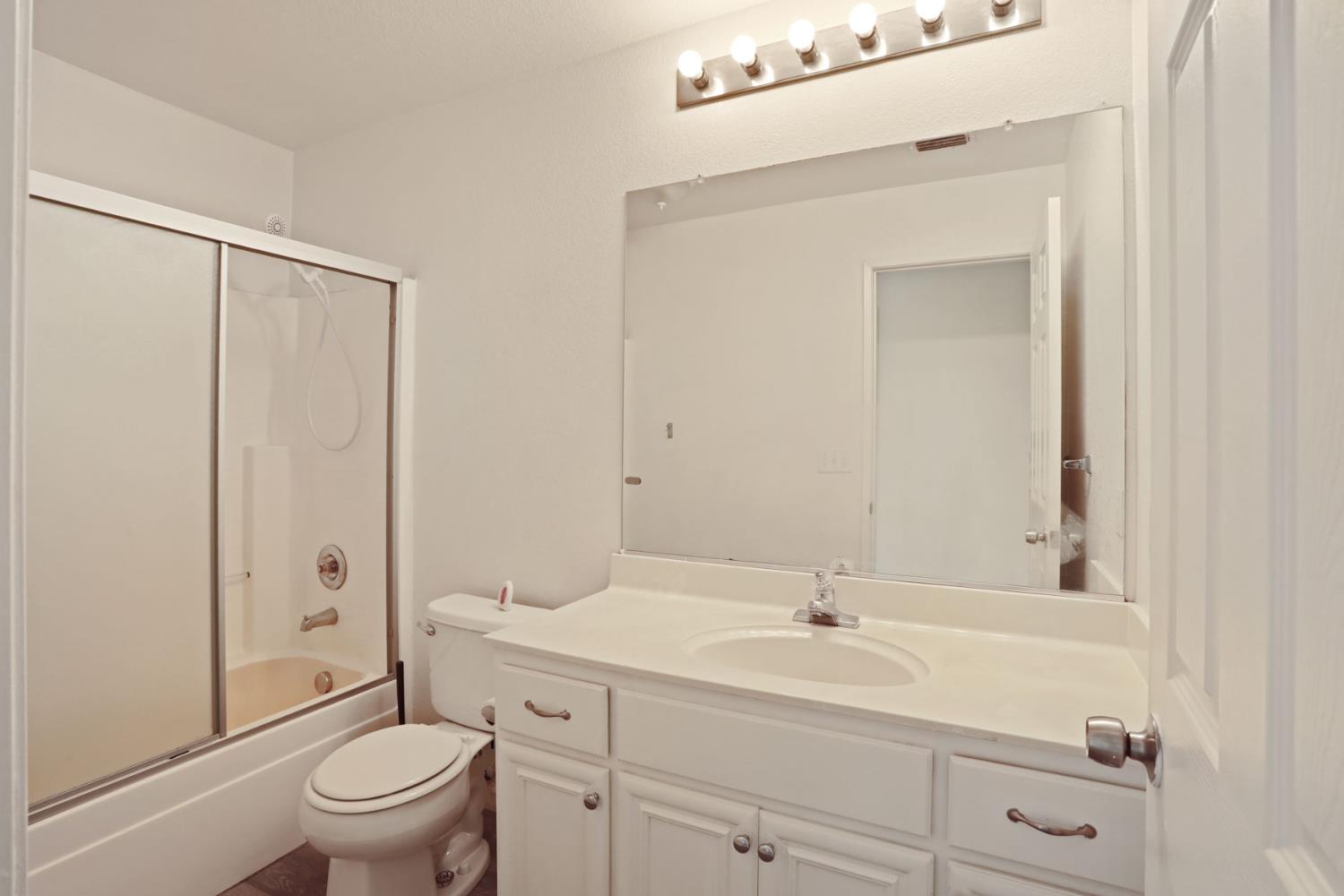 4882 Timepiece Circle Stockton, CA 95219 - Photo 25 of 43 a bathroom with a sink a toilet and a mirror