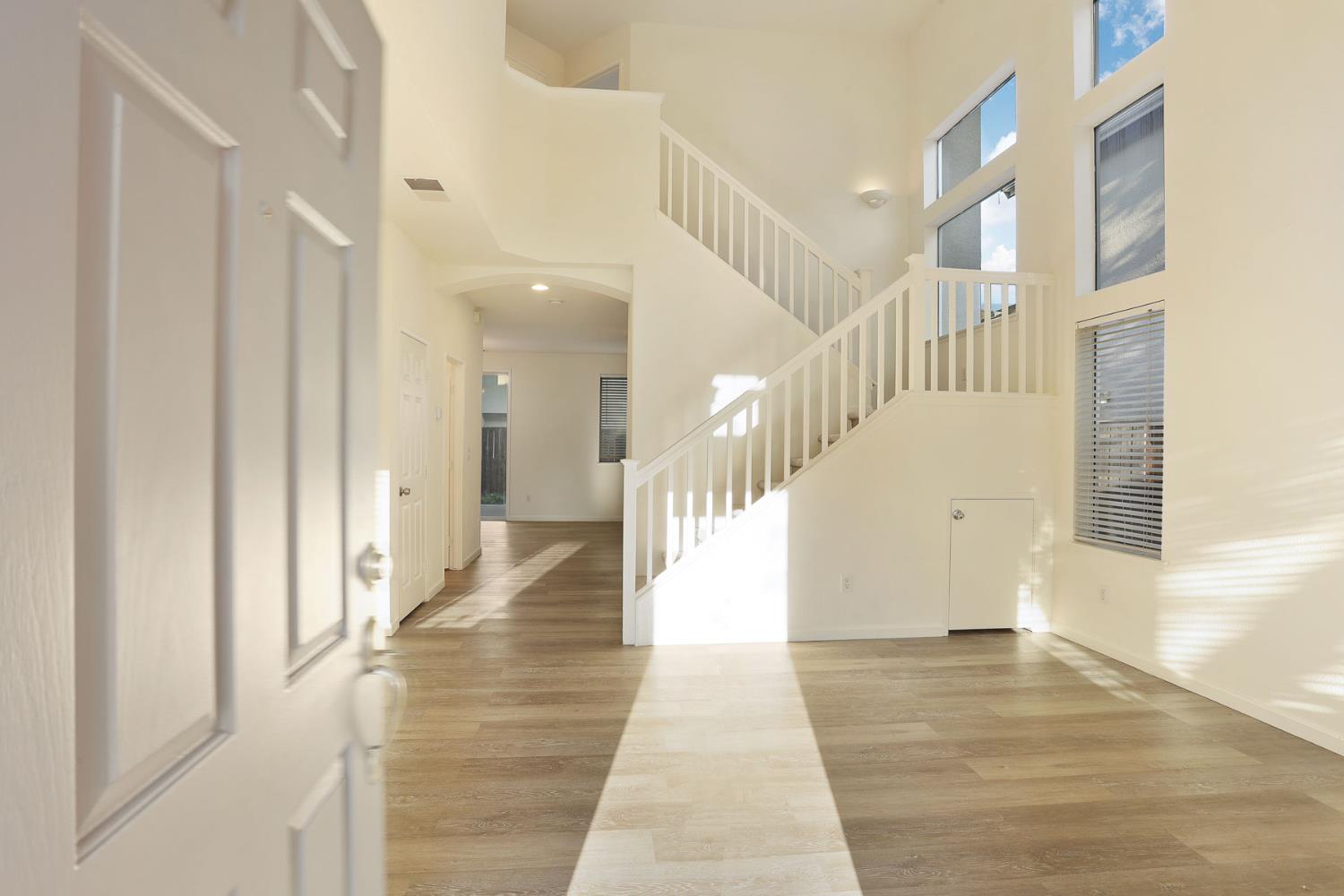 4882 Timepiece Circle Stockton, CA 95219 - Photo 4 of 43 a view of staircase with lots of frames on wall and a large window