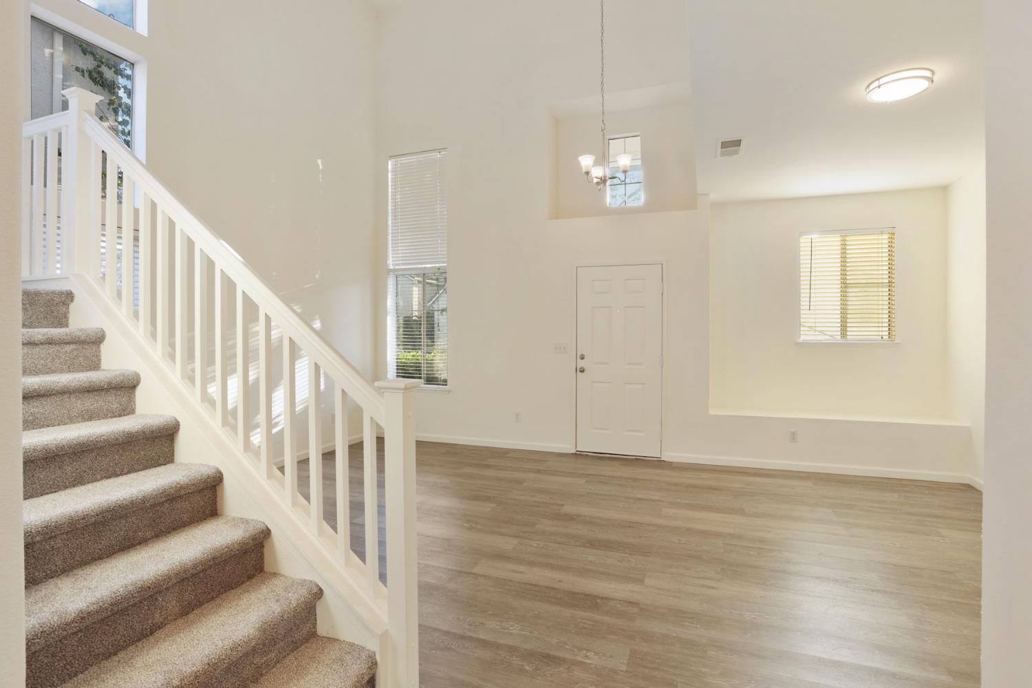 4882 Timepiece Circle Stockton, CA 95219 - Photo 9 of 43 a view of an entryway with wooden floor and staircase