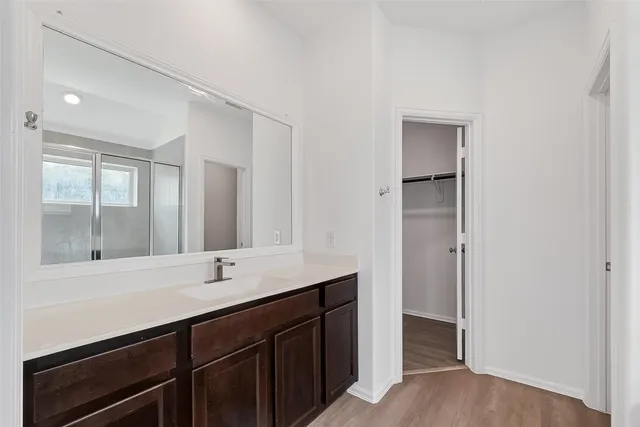 a bathroom with a double vanity sink and mirror