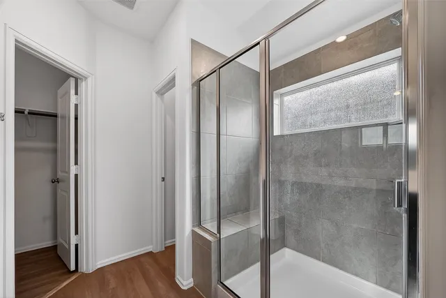a bathroom with a glass shower door