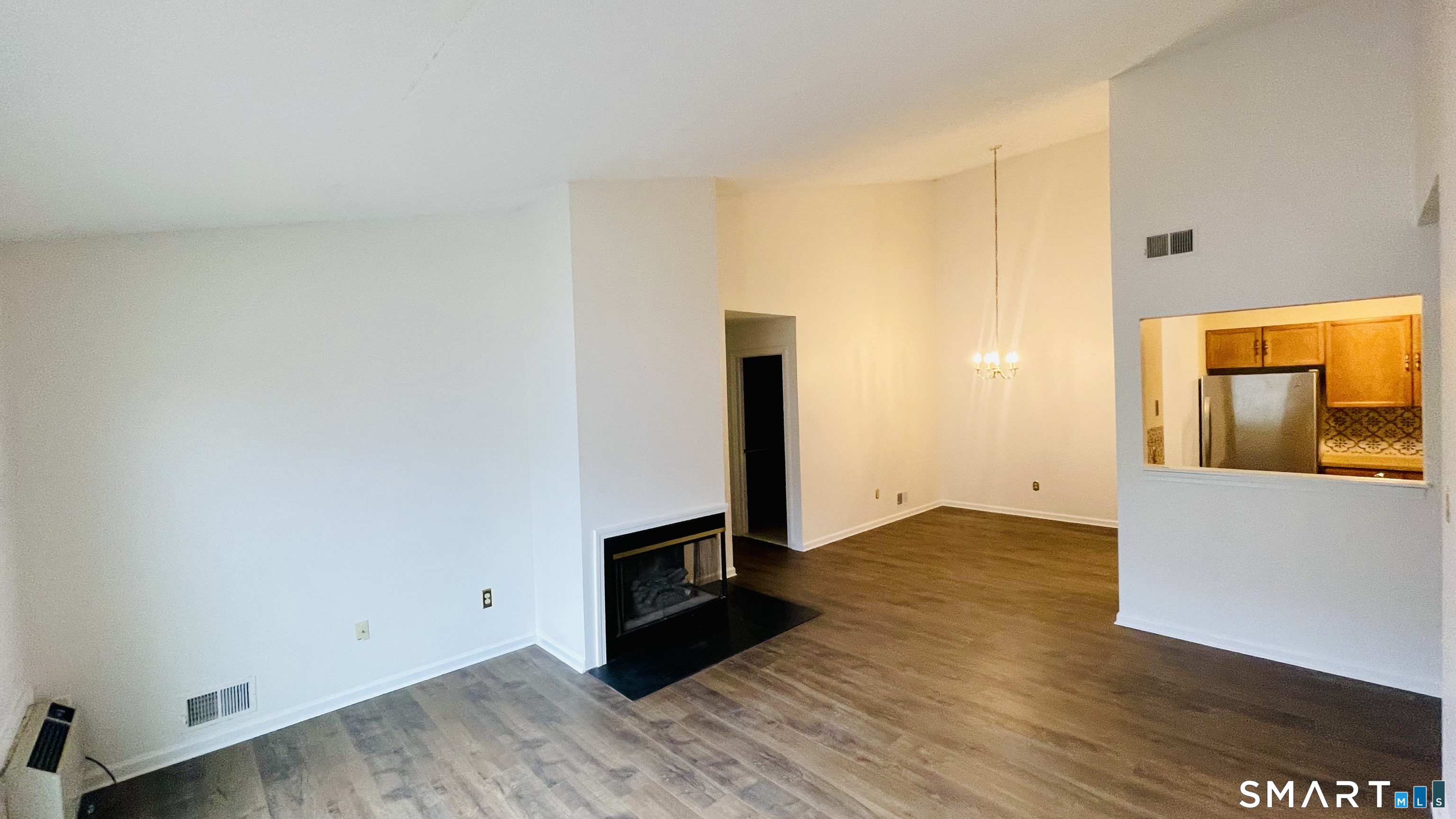 68 Rockledge Loop, Unit 68 Torrington, CT 06790 - Photo 6 of 24 a view of an empty room with wooden floor