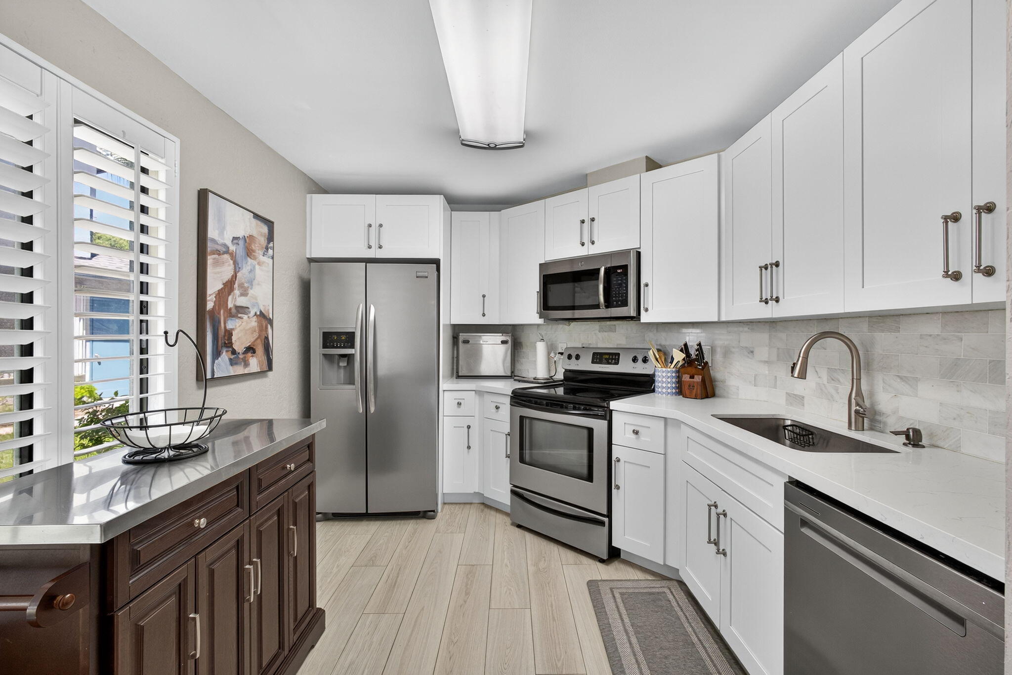 406 Harbour Pointe Way Greenacres, FL 33413 - Photo 26 of 79 a kitchen with stainless steel appliances granite countertop white cabinets a sink a stove a refrigerator and dishwasher with wooden floor