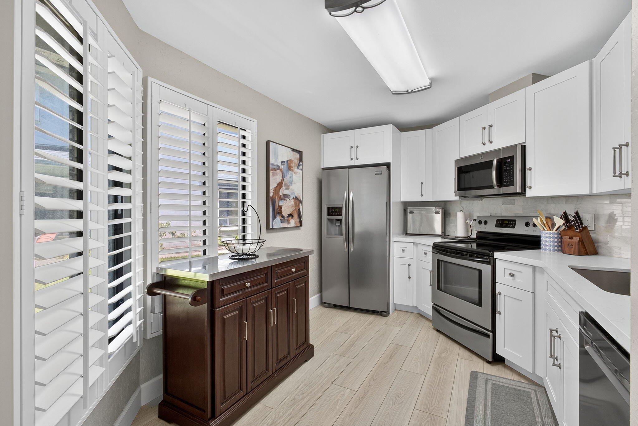 406 Harbour Pointe Way Greenacres, FL 33413 - Photo 27 of 79 a kitchen with stainless steel appliances a refrigerator a sink a stove and cabinets