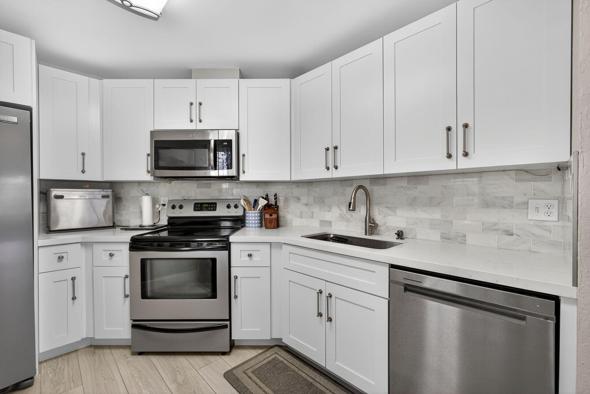 406 Harbour Pointe Way Greenacres, FL 33413 - Photo 30 of 79 a kitchen with cabinets stainless steel appliances and sink