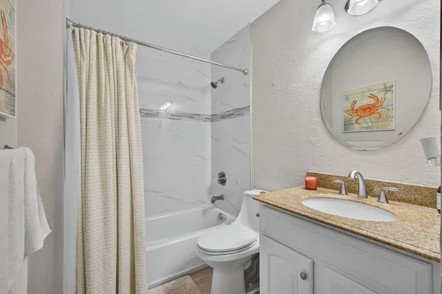 a view of a porch with furniture and wooden floor