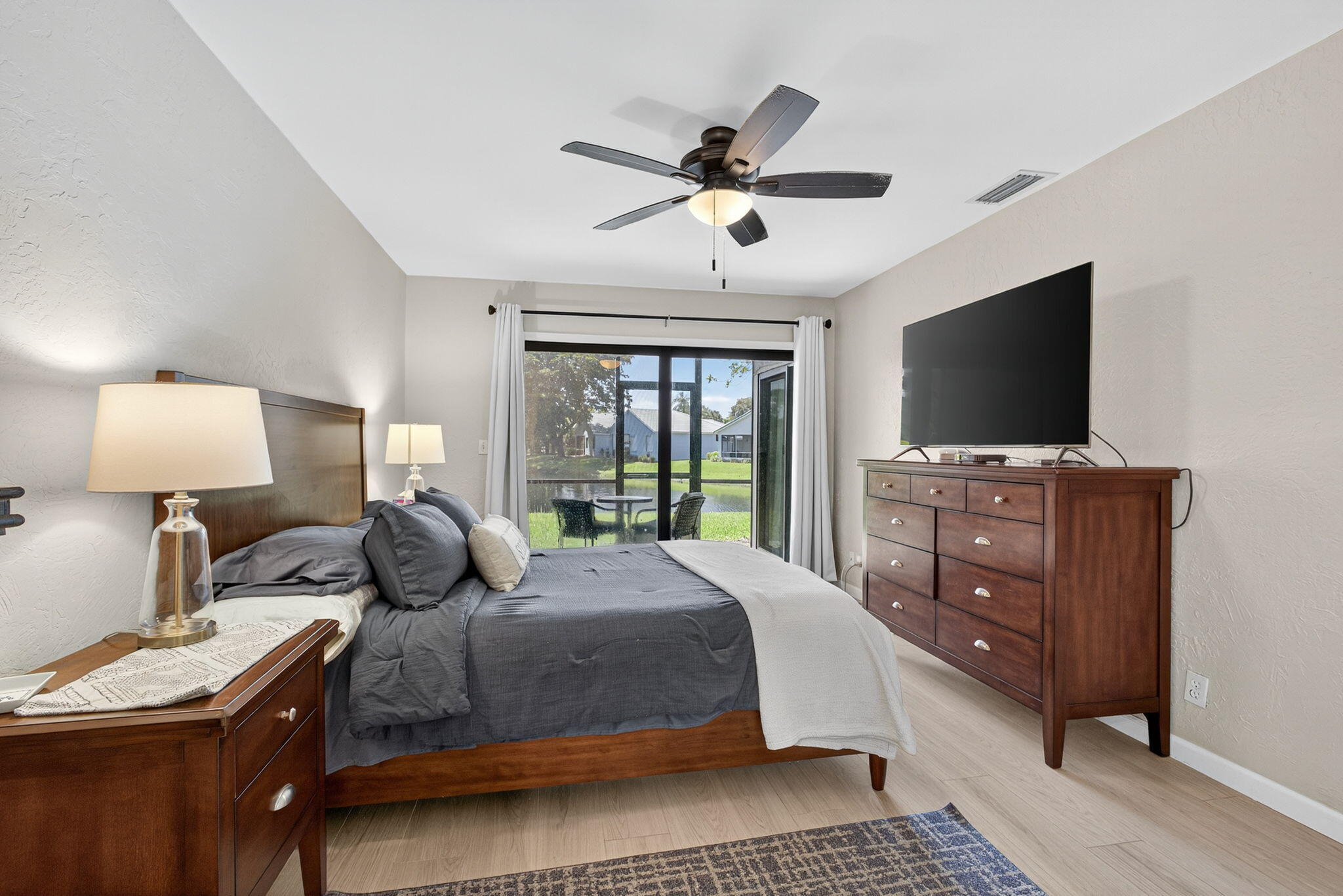 406 Harbour Pointe Way Greenacres, FL 33413 - Photo 39 of 79 a bedroom with a bed and a flat screen tv