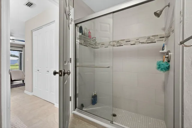 an aerial view of a house with a yard and lake view