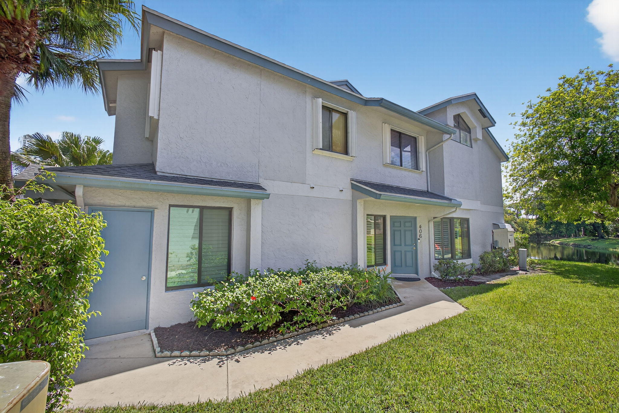 406 Harbour Pointe Way Greenacres, FL 33413 - Photo 8 of 79 a front view of a house with a yard and potted plants