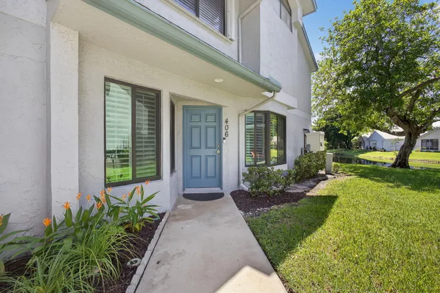 a view of a dining room with furniture a chandelier and wooden floor