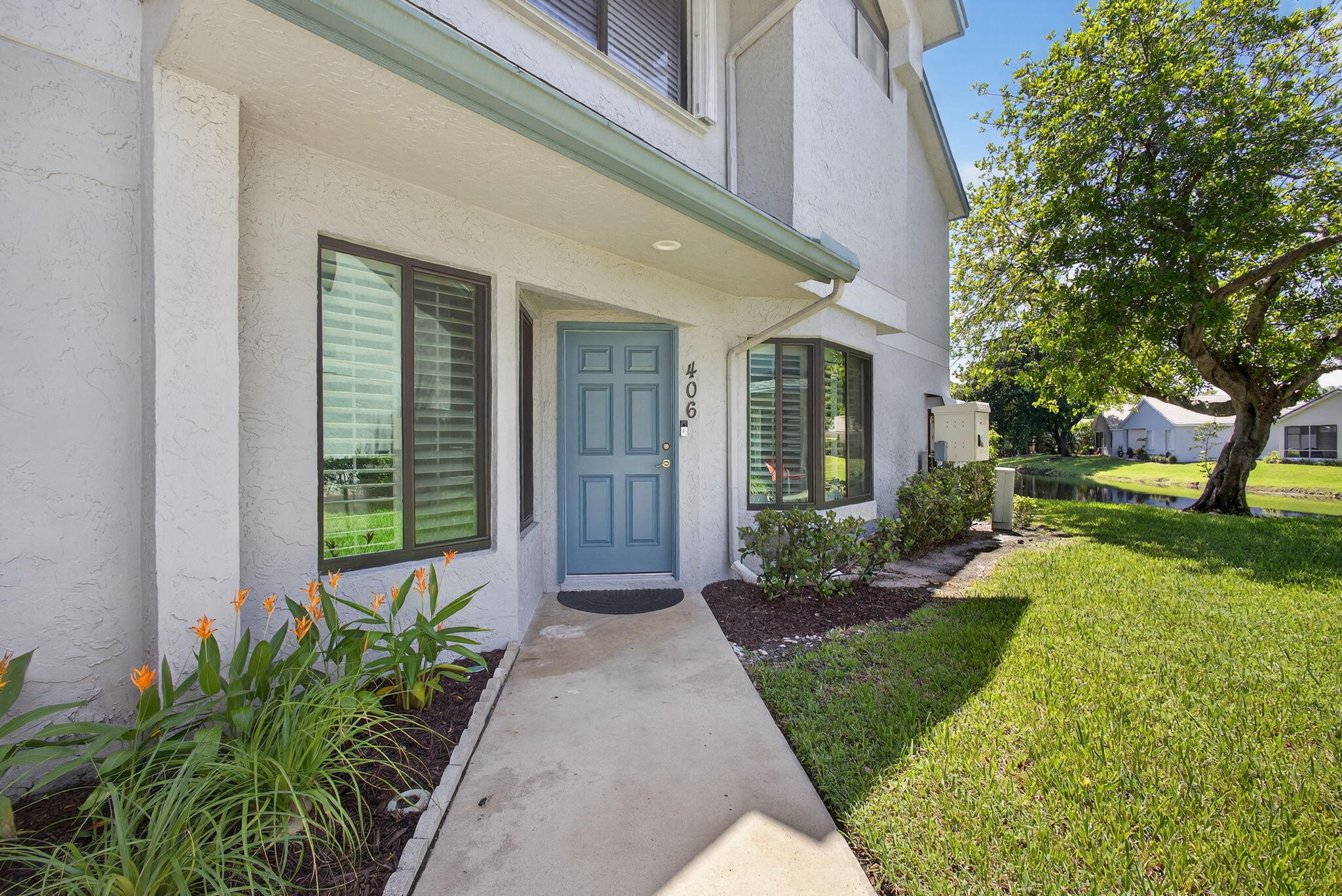 406 Harbour Pointe Way Greenacres, FL 33413 - Photo 10 of 79 a front view of a house with a yard