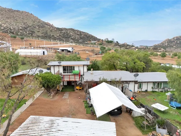 an aerial view of a house with a yard