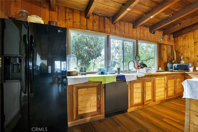 a living room with large windows and a table