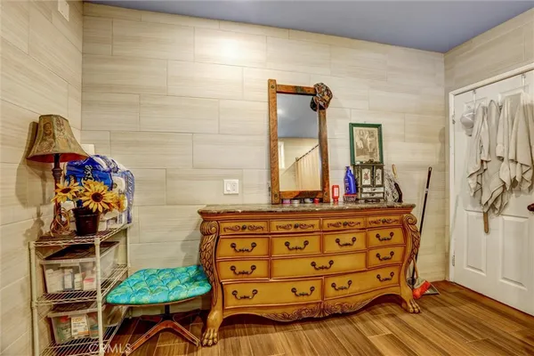 a dining room with stainless steel appliances kitchen island granite countertop a table chairs and a rug