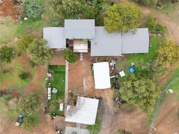 an aerial view of a house with garden space and street view