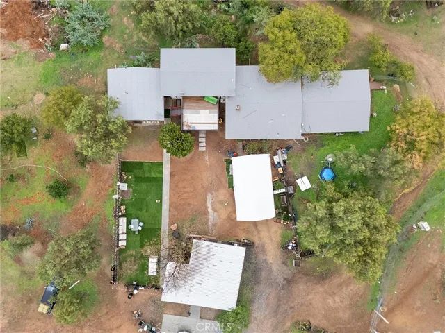 an aerial view of a house with garden space and street view