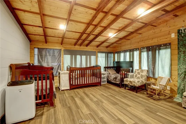 a bedroom with a bed a couch and a chandelier