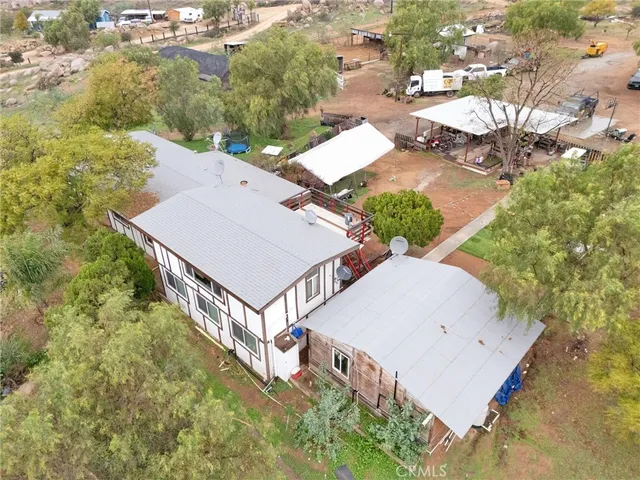 an aerial view of a house with yard