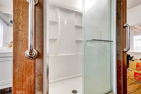 a bed sitting in a bedroom next to a window