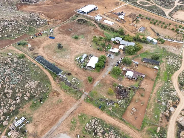 an aerial view of house with yard and mountain view in back