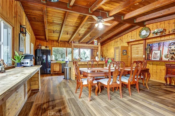 a dining room with furniture and wooden floor