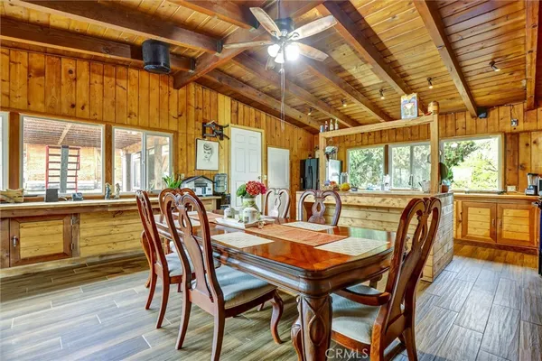 a living room with large windows and a table