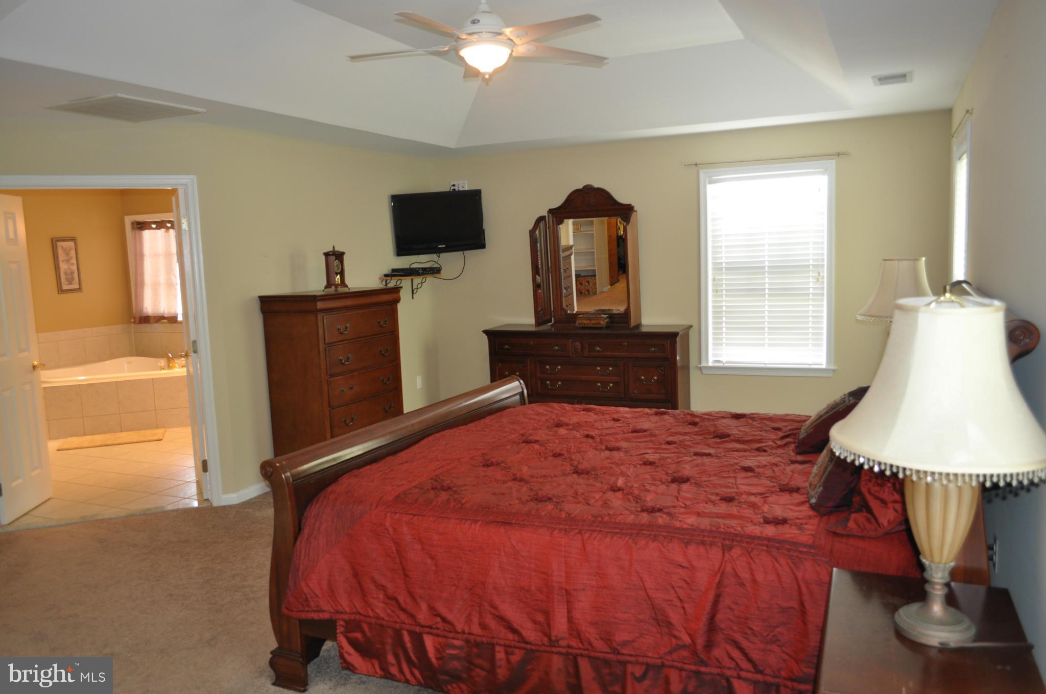 3907 Pender Spring Drive Fairfax, VA 22033 - Photo 14 of 30 a bedroom with a bed and a flat tv screen on dresser