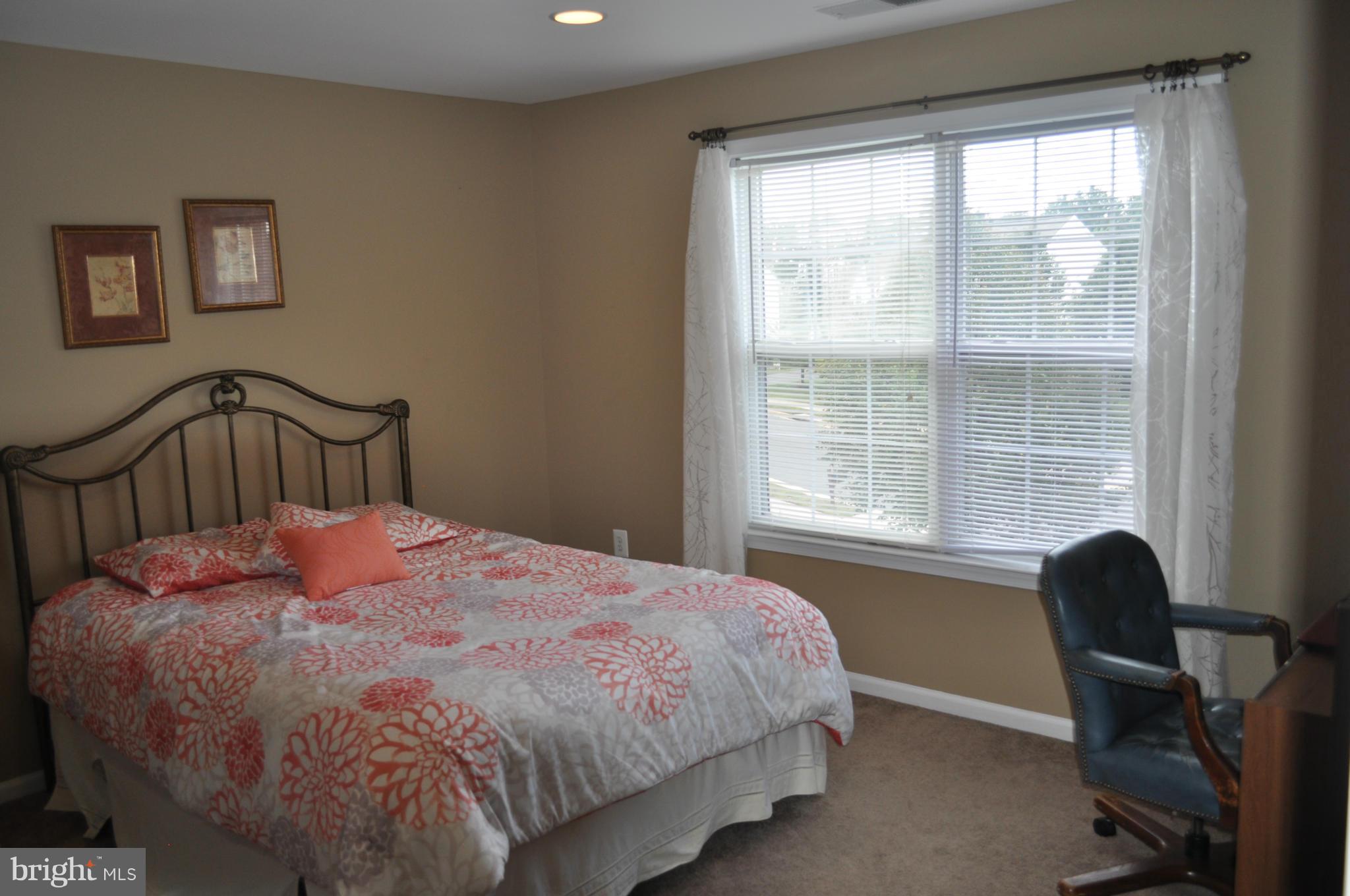 3907 Pender Spring Drive Fairfax, VA 22033 - Photo 20 of 30 a bedroom with a bed a table and a window