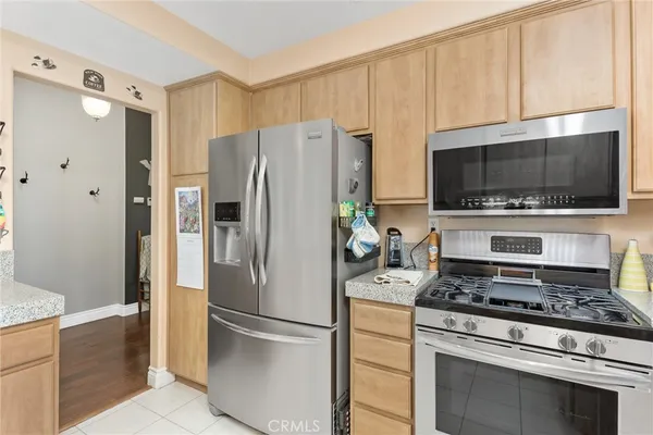 a kitchen with a refrigerator stove and microwave