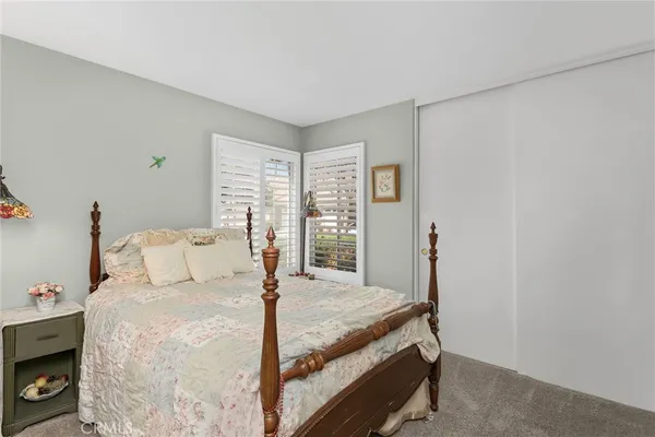 a bedroom with a bed and a tv