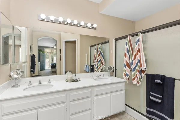 a bathroom with a double vanity sink and a mirror