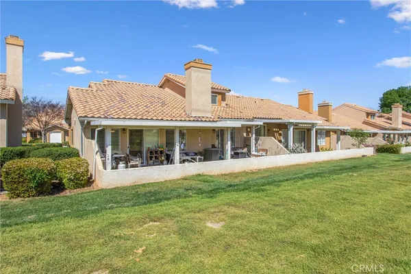 a front view of a house with swimming pool having outdoor seating