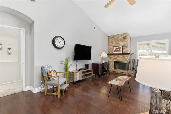 a living room with furniture a fireplace and a flat screen tv