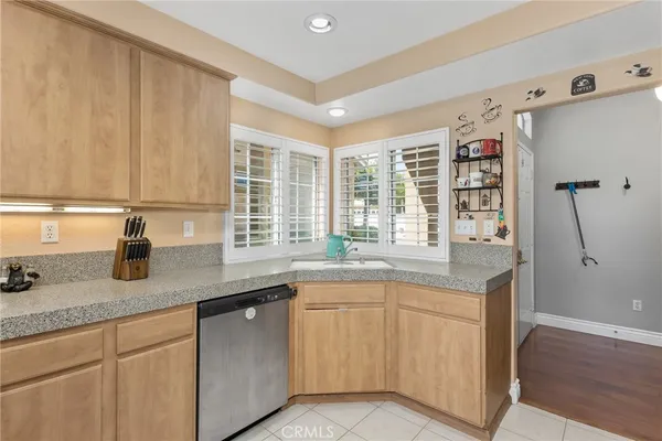 a kitchen with stainless steel appliances granite countertop a sink and a granite counter tops with wooden floors