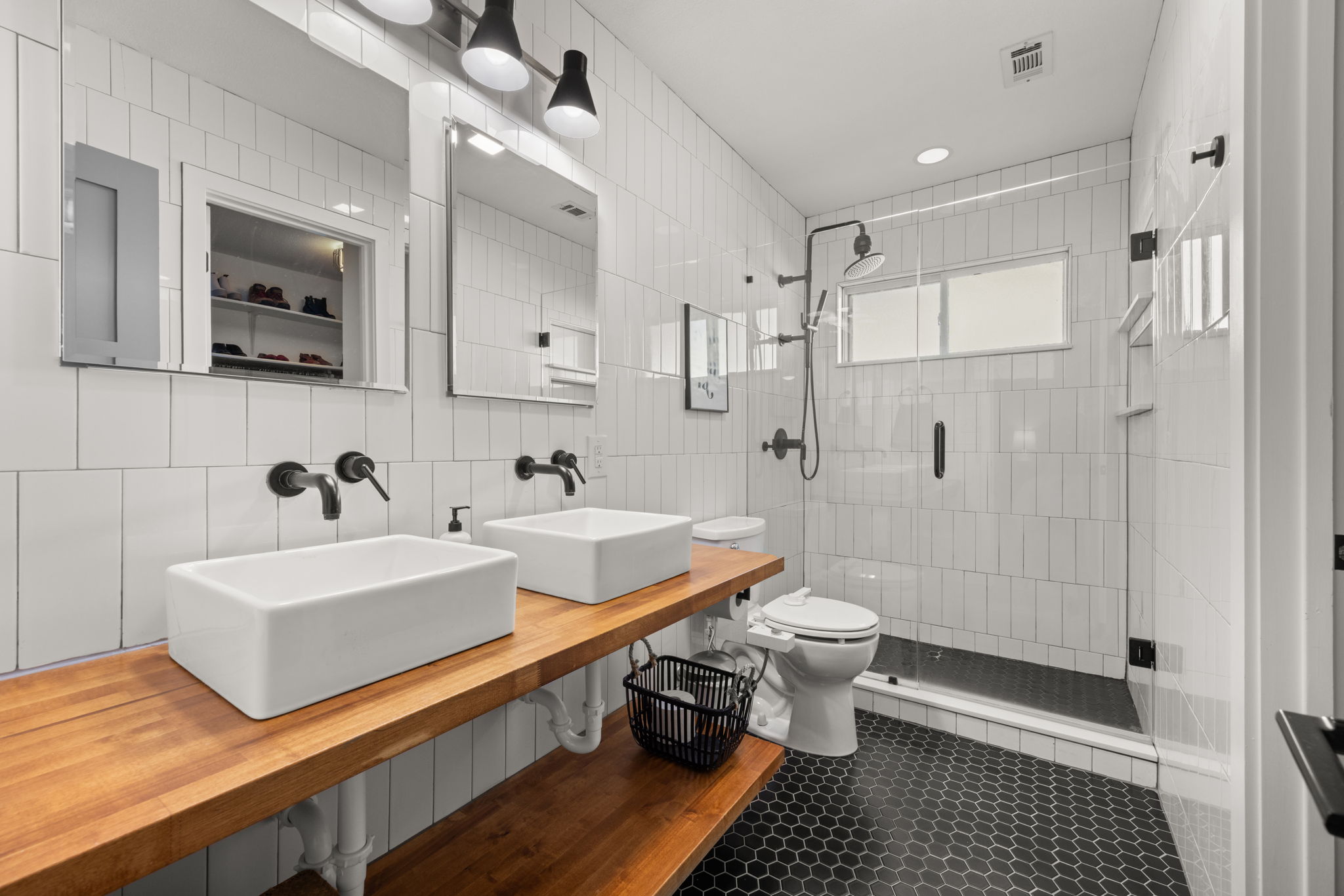8401 Alabama Drive Austin, TX 78745 - Photo 12 of 23 a bathroom with a double vanity sink mirror and toilet