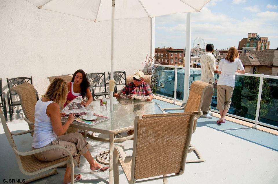820 Ocean Avenue, Unit 115 Ocean City, NJ 08226 - Photo 14 of 58 a view of a dining room with furniture water and mountain view