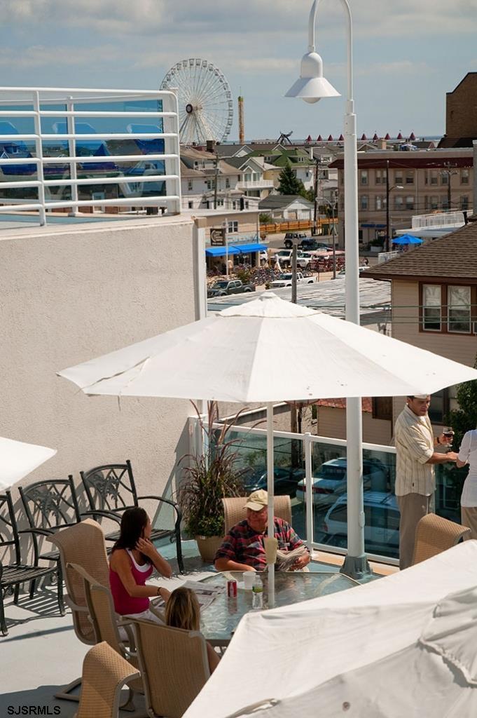 820 Ocean Avenue, Unit 115 Ocean City, NJ 08226 - Photo 16 of 58 a terrace with outdoor seating and city view