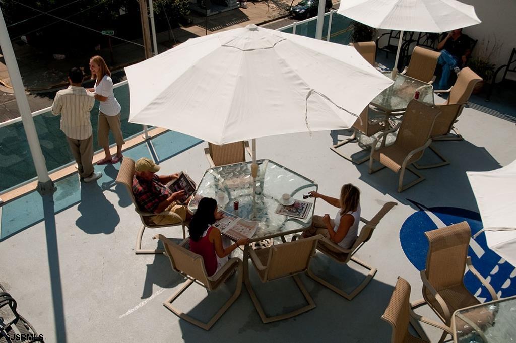 820 Ocean Avenue, Unit 115 Ocean City, NJ 08226 - Photo 19 of 58 a view of a tables and chairs in patio