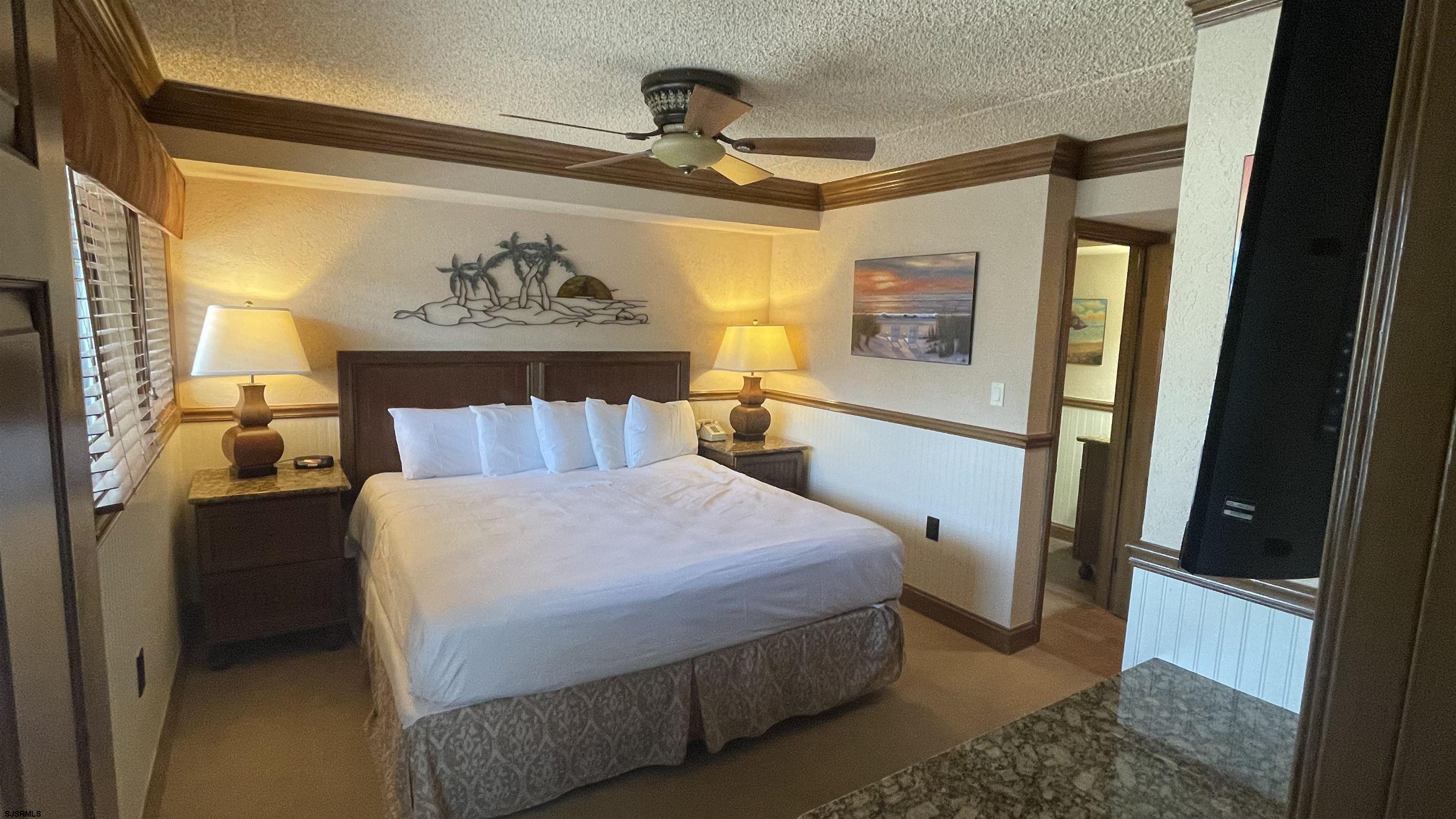 820 Ocean Avenue, Unit 115 Ocean City, NJ 08226 - Photo 24 of 58 a bedroom with a bed and a mirror